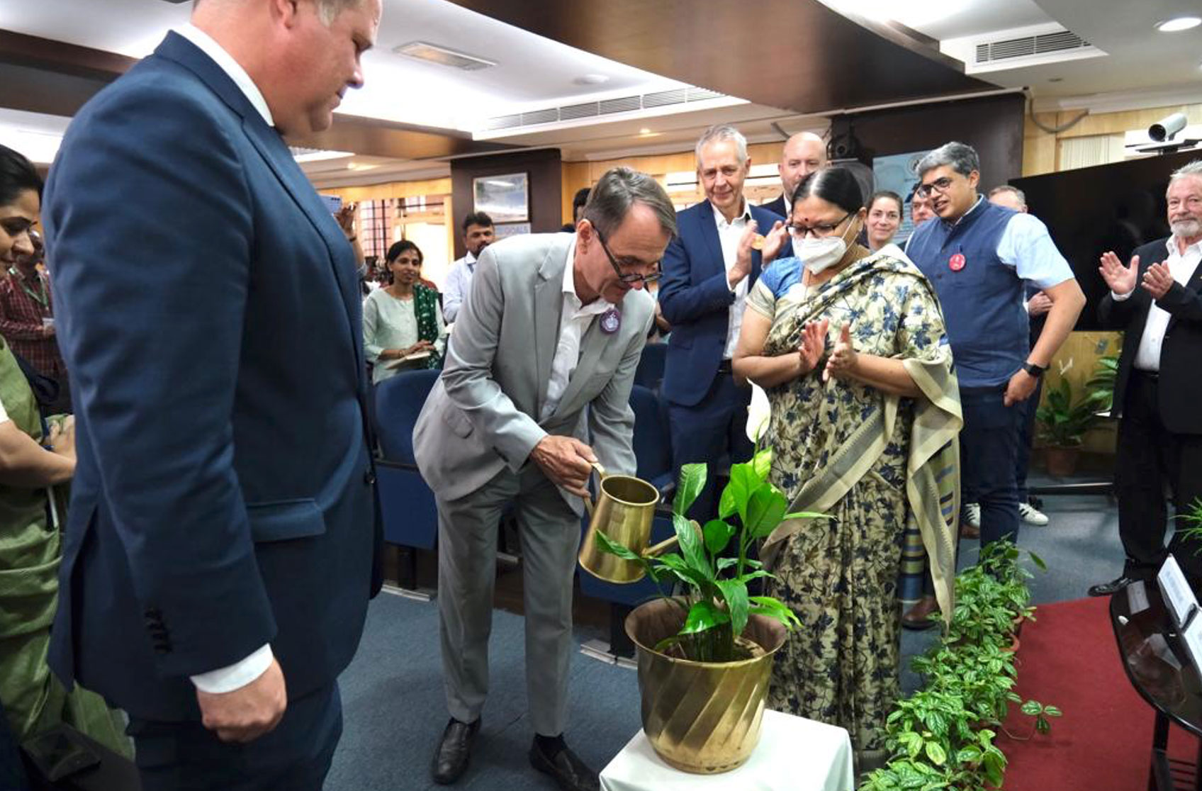 Achim Burkert, German Consul General watering a plant [GIZ]